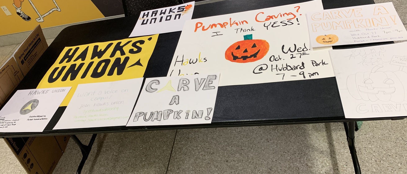 Table with Hawks' Union signs.